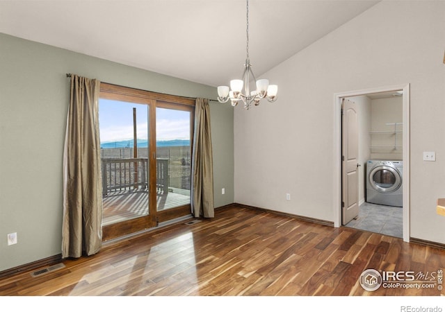 unfurnished dining area with a mountain view, wood finished floors, visible vents, vaulted ceiling, and washer / clothes dryer