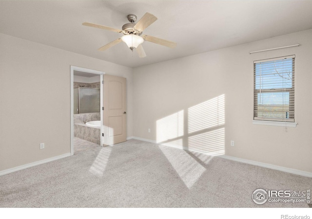 unfurnished bedroom featuring a ceiling fan, light colored carpet, baseboards, and ensuite bathroom