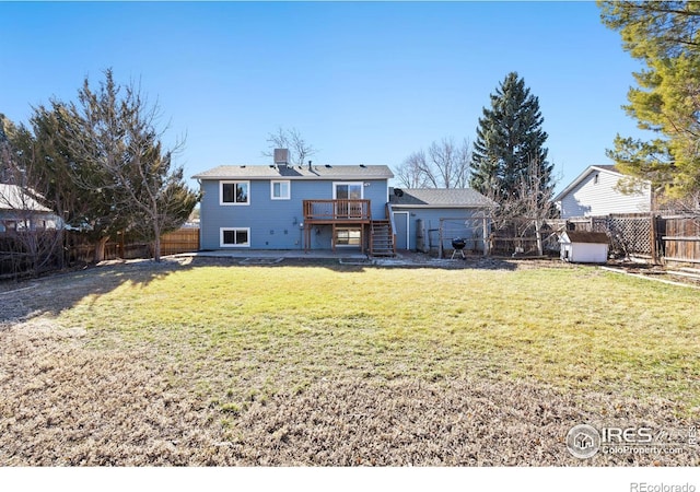 rear view of property featuring stairs, a yard, a deck, and a fenced backyard