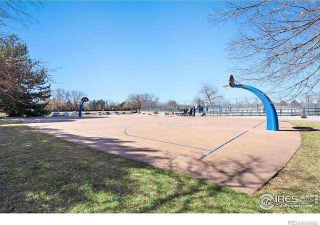 view of sport court featuring community basketball court, a yard, and fence