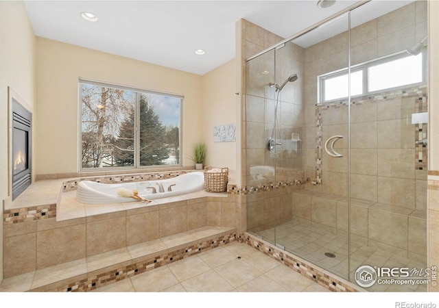 bathroom featuring a garden tub, recessed lighting, tiled shower, and tile patterned floors