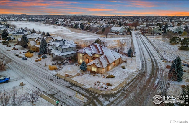 snowy aerial view with a residential view