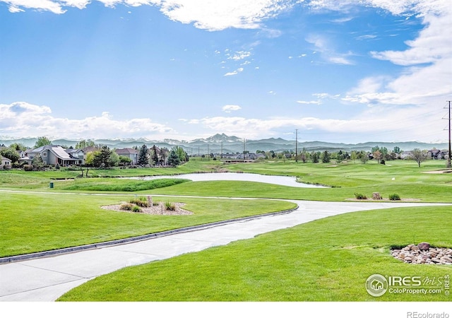 surrounding community featuring a mountain view, golf course view, and a yard