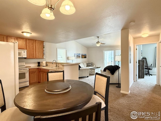 4645 Hahns Peak Dr Unit 201, Loveland, CO 80538 - dining room featuring a ceiling fan, light colored carpet, a textured ceiling, baseboards, and vaulted ceiling