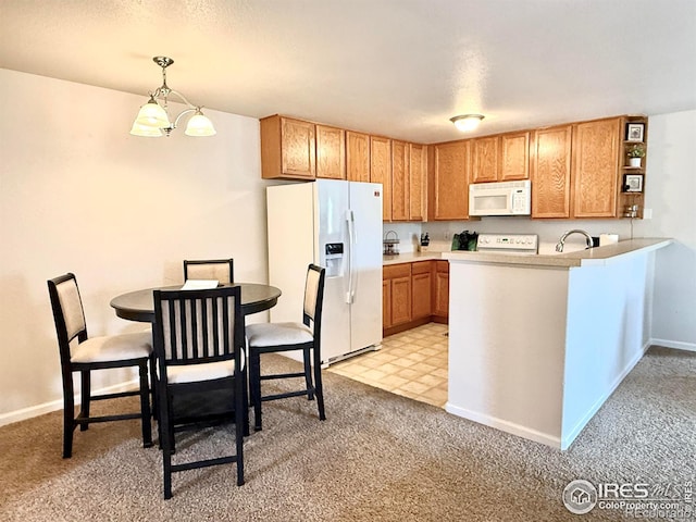 4645 Hahns Peak Dr Unit 201, Loveland, CO 80538 - kitchen featuring white appliances, light colored carpet, light countertops, a sink, and a peninsula