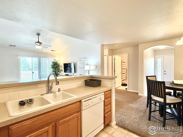 4645 Hahns Peak Dr Unit 201, Loveland, CO 80538 - kitchen featuring white dishwasher, a textured ceiling, a sink, arched walkways, and ceiling fan