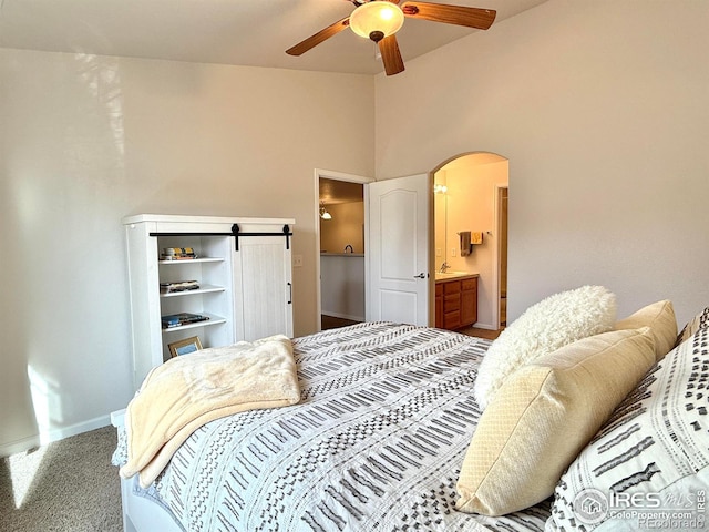4645 Hahns Peak Dr Unit 201, Loveland, CO 80538 - carpeted bedroom with baseboards, arched walkways, high vaulted ceiling, ceiling fan, and ensuite bath