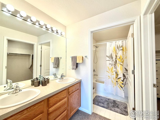 4645 Hahns Peak Dr Unit 201, Loveland, CO 80538 - bathroom with double vanity, toilet, shower / tub combo, tile patterned floors, and a walk in closet