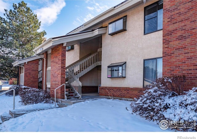 snow covered building with stairs