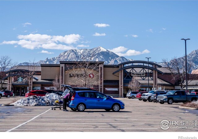 uncovered parking lot featuring a mountain view