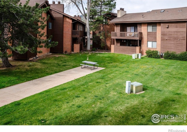 view of home's community with a yard