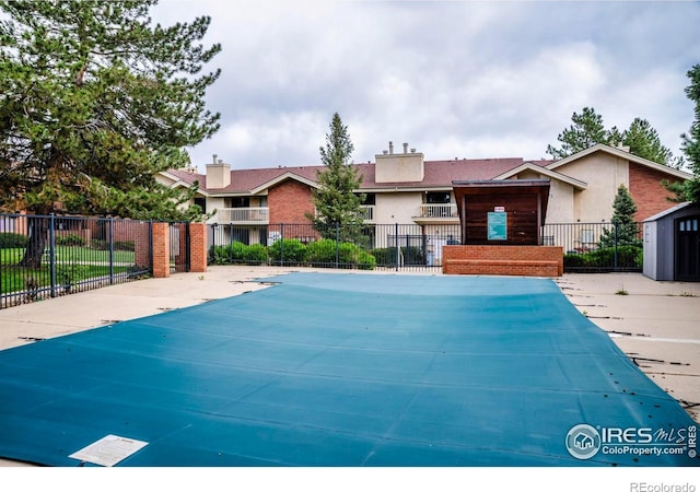 view of swimming pool featuring fence