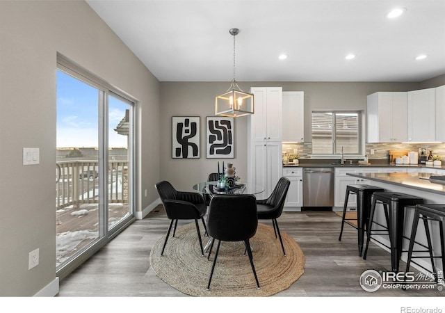 dining area with recessed lighting, baseboards, and wood finished floors