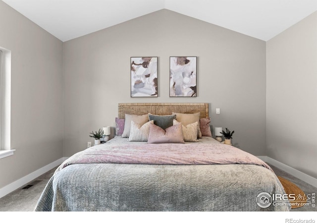 carpeted bedroom with vaulted ceiling, visible vents, and baseboards