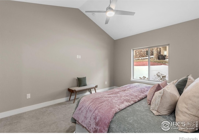 carpeted bedroom with lofted ceiling, baseboards, and a ceiling fan