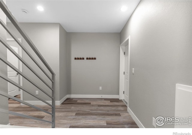 interior space featuring stairway, baseboards, wood finished floors, and recessed lighting