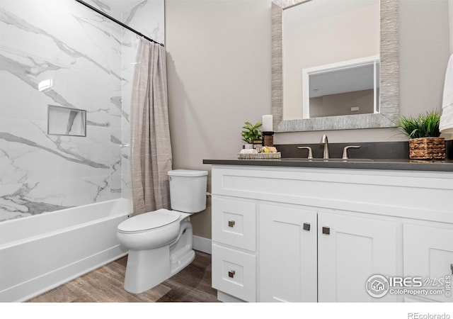 bathroom featuring vanity, wood finished floors, shower / bath combination with curtain, and toilet