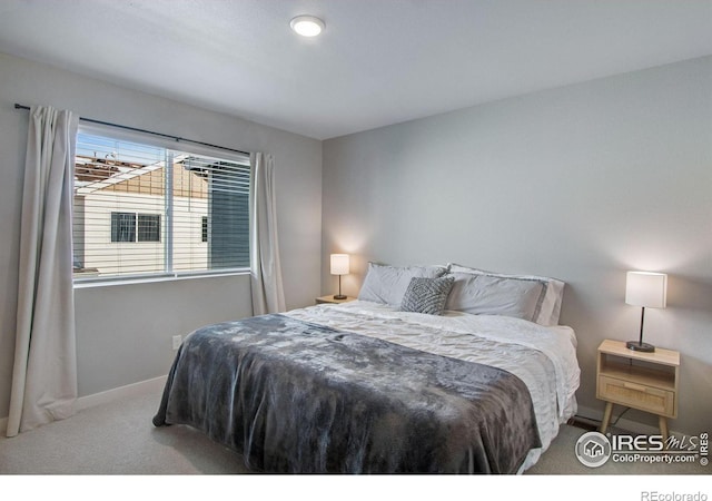 bedroom featuring baseboards and light colored carpet