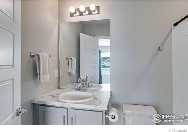 bathroom featuring toilet and vanity