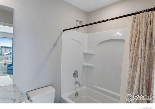 bathroom with shower / tub combo and toilet