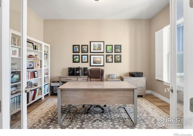 office with a wealth of natural light, baseboards, and wood finished floors