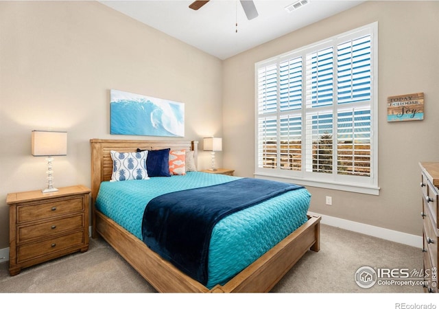 bedroom with light carpet, a ceiling fan, visible vents, and baseboards