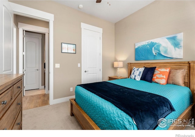 bedroom featuring baseboards, a ceiling fan, and light colored carpet