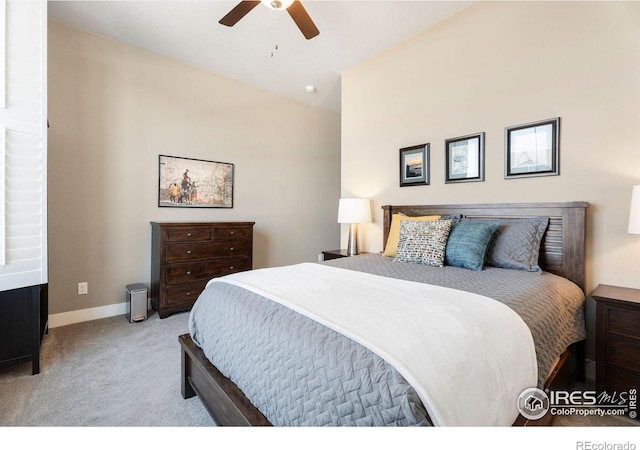 bedroom featuring light carpet, ceiling fan, and baseboards