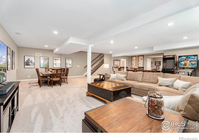 living room with light carpet, stairway, and recessed lighting