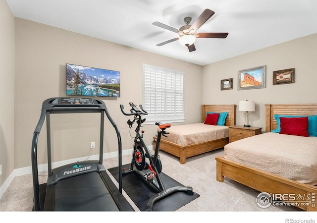 bedroom with light colored carpet, ceiling fan, and baseboards