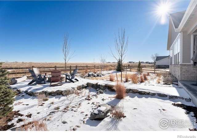 yard covered in snow featuring a fire pit