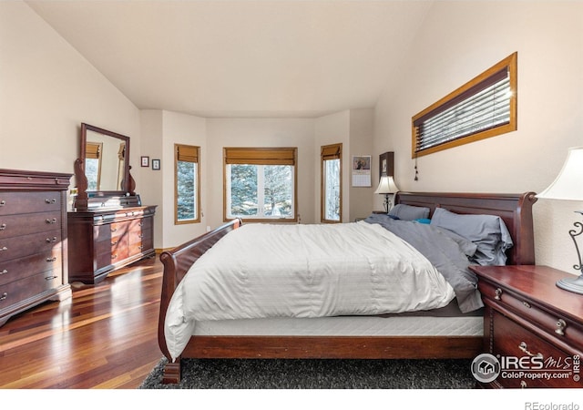 bedroom with dark wood-type flooring