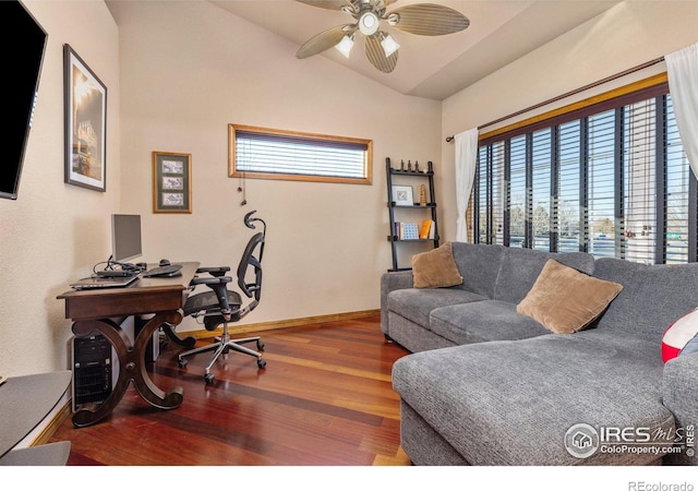 office area with vaulted ceiling, ceiling fan, wood finished floors, and a healthy amount of sunlight