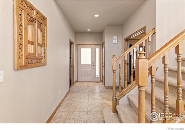 entryway with stairway, light tile patterned floors, baseboards, and recessed lighting