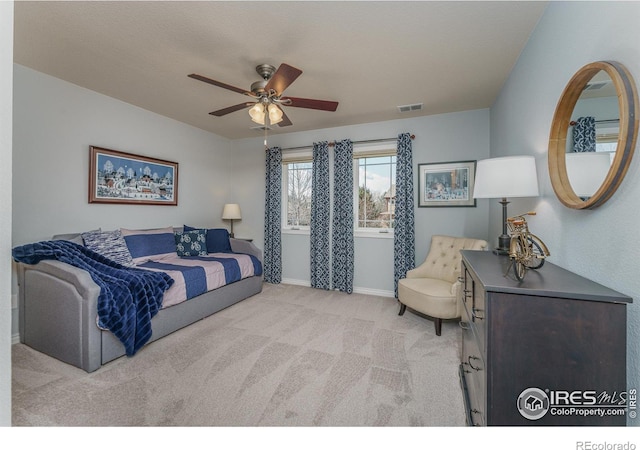 bedroom featuring a ceiling fan, light carpet, visible vents, and baseboards