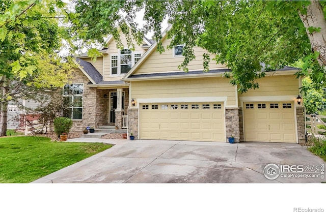 craftsman-style house with driveway, stone siding, and a garage