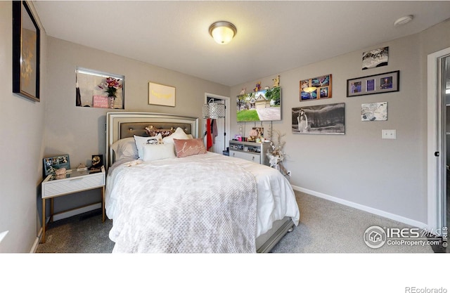 carpeted bedroom featuring baseboards