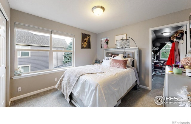 carpeted bedroom featuring baseboards