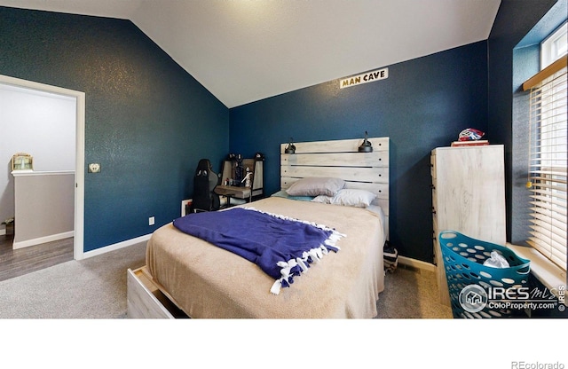 bedroom with carpet, vaulted ceiling, and baseboards