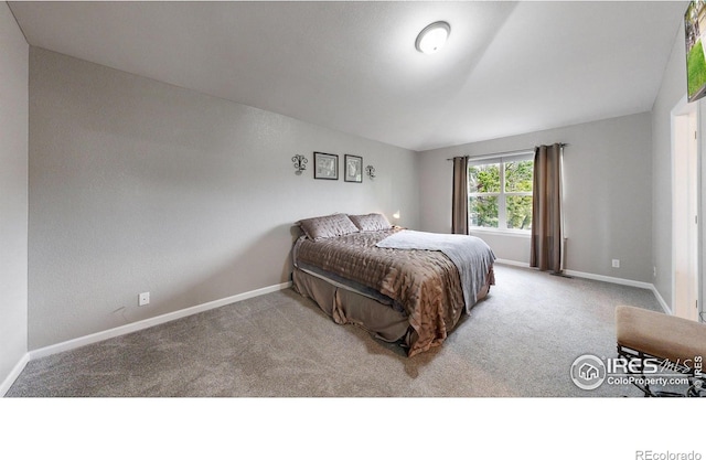 carpeted bedroom featuring baseboards