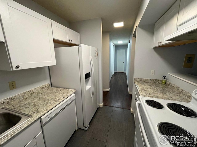 kitchen featuring white appliances, light stone counters, wood tiled floor, white cabinetry, and a sink