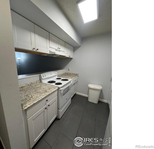 kitchen with light stone counters, white electric range oven, white cabinets, under cabinet range hood, and baseboards