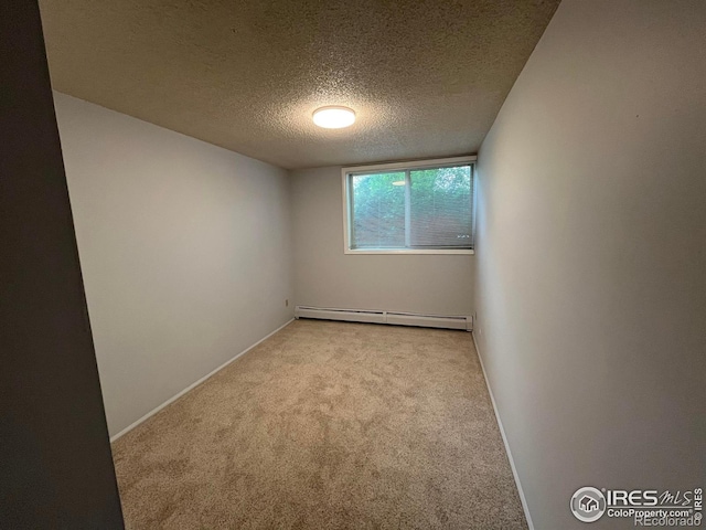 2707 Valmont Rd Unit 111A, Boulder, CO 80304 - carpeted empty room featuring a baseboard heating unit and a textured ceiling