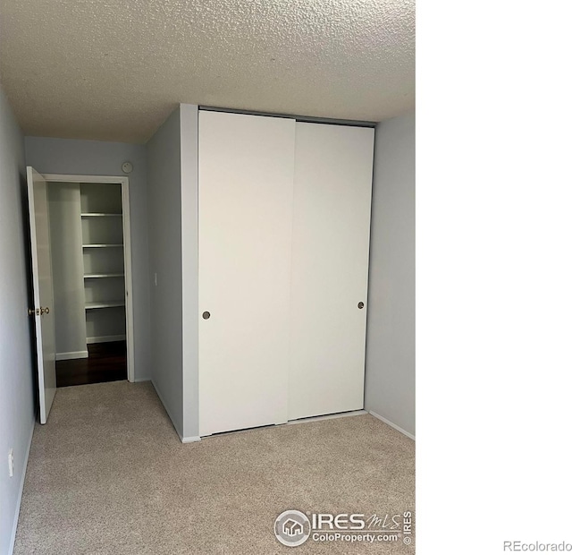 2707 Valmont Rd Unit 111A, Boulder, CO 80304 - unfurnished bedroom with a closet, light colored carpet, and a textured ceiling