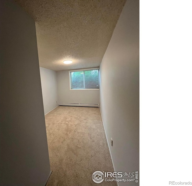 2707 Valmont Rd Unit 111A, Boulder, CO 80304 - carpeted empty room featuring a baseboard radiator and a textured ceiling