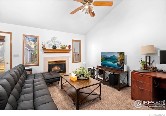 living room featuring lofted ceiling, ceiling fan, a fireplace, and light colored carpet