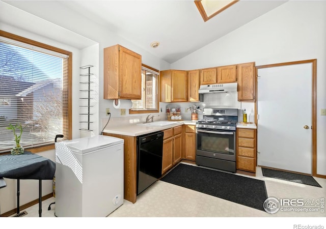 kitchen with black dishwasher, light countertops, under cabinet range hood, stainless steel gas range oven, and fridge