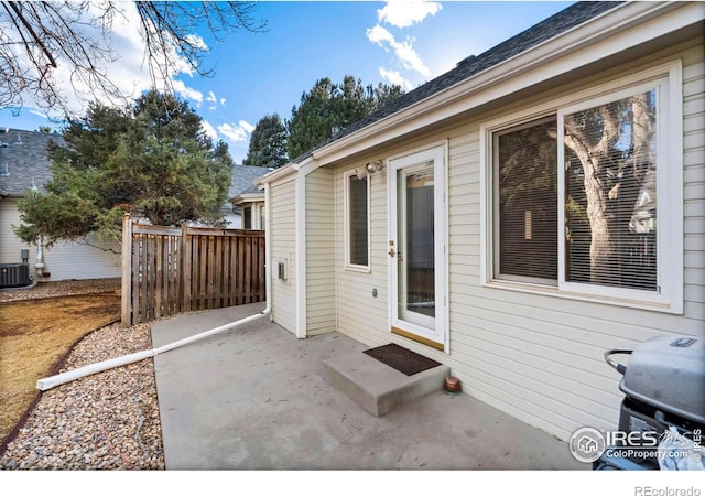 view of patio / terrace featuring grilling area, fence, and central air condition unit