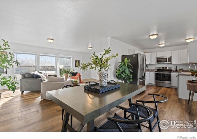 dining space with wood finished floors