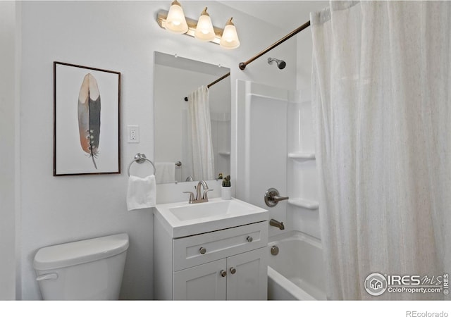 bathroom featuring vanity, toilet, and shower / tub combo with curtain